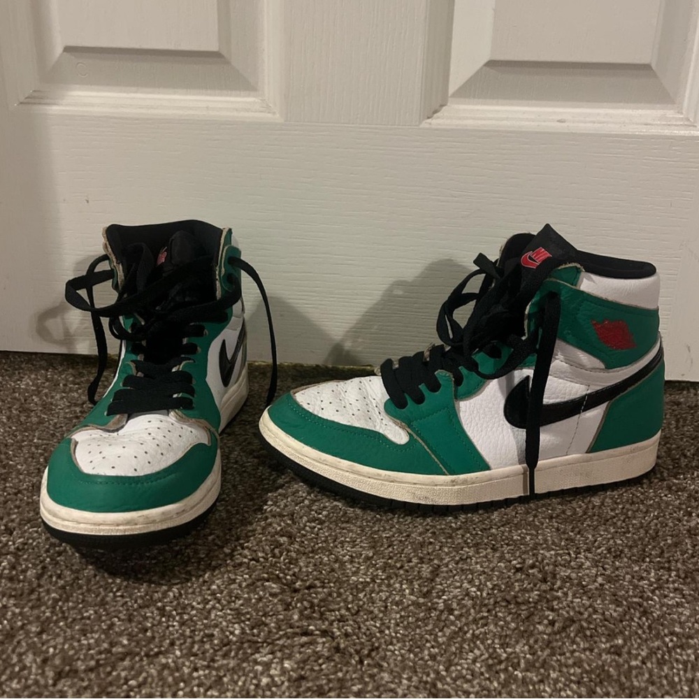 White and green Nike Jordan high tops. With green and red laces.
